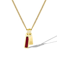 Gold necklace with a red pendant on a white background
