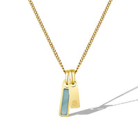 Gold necklace with a pendant on a white background