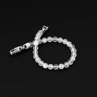 Beaded bracelet with silver clasp on a black background