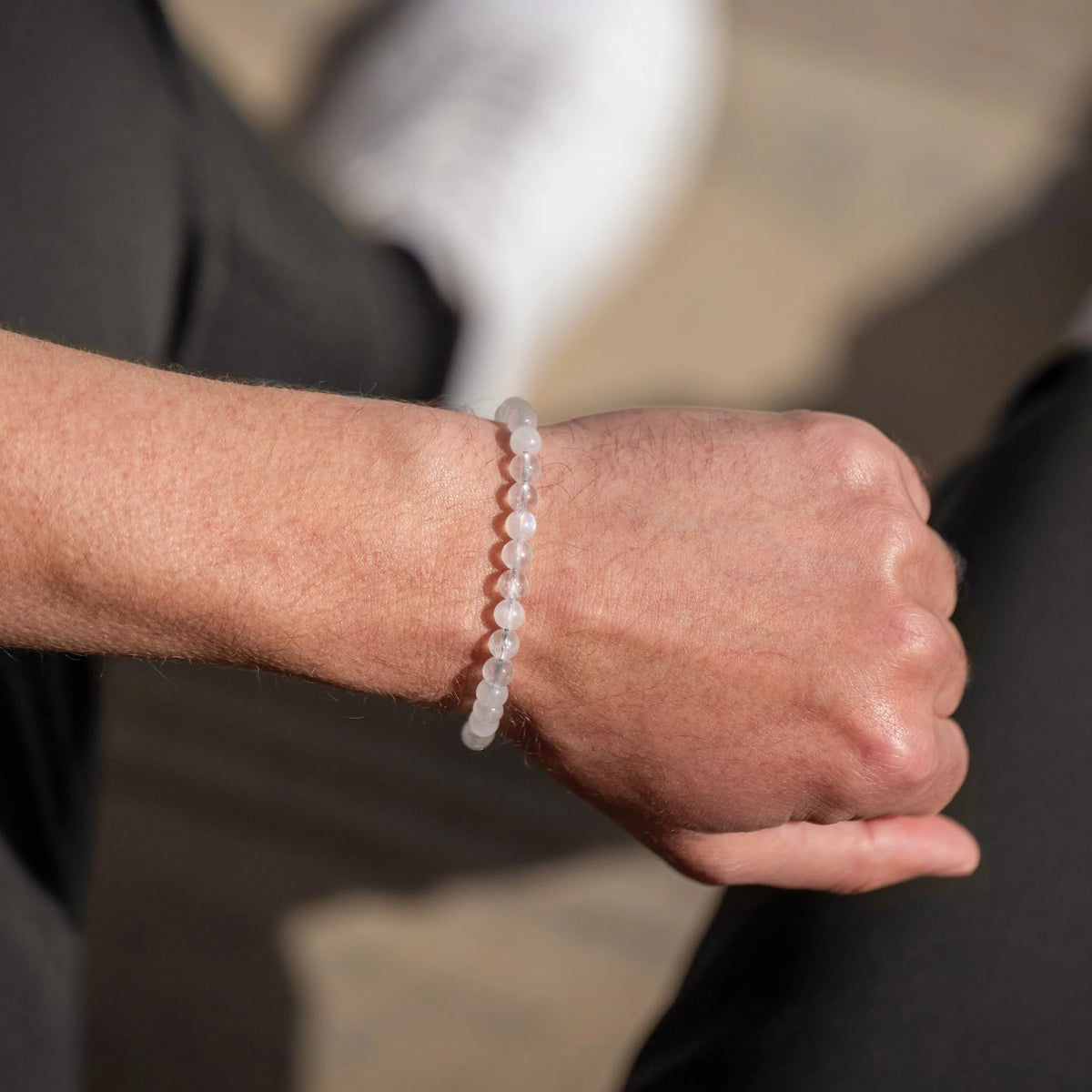 Close-up of a wrist wearing a bracelet with a blurred background