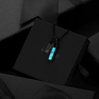 Necklace with pendant on a black box against a dark background