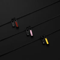 Three zipper pullers with different color options on a black background