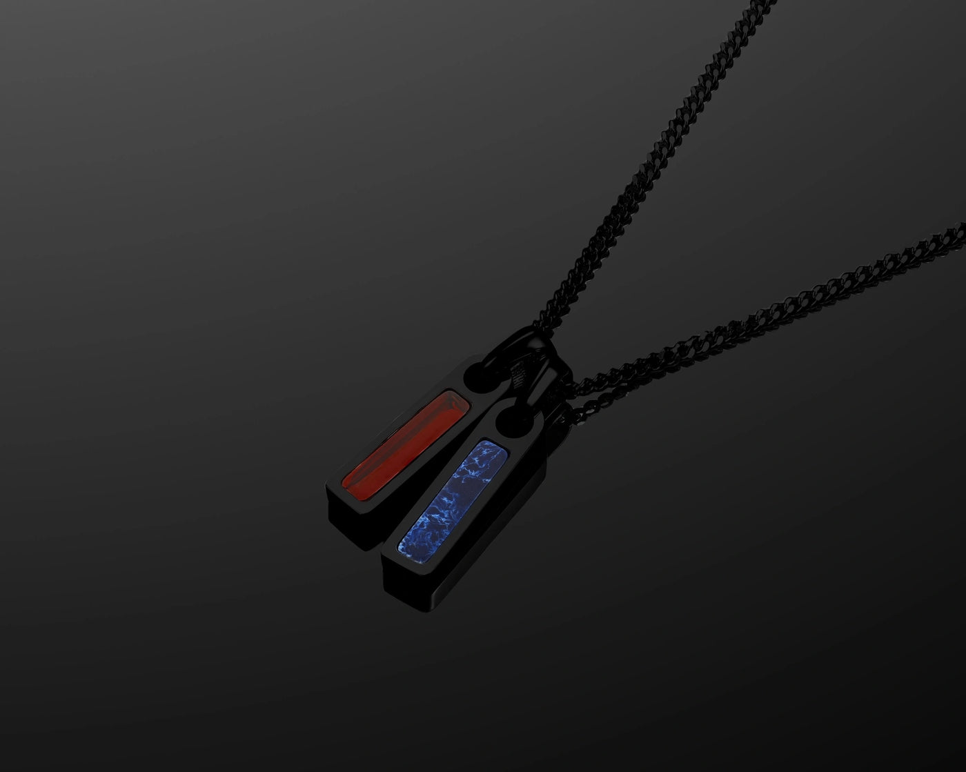 Necklace with red and blue pendant on a black chain against a dark background