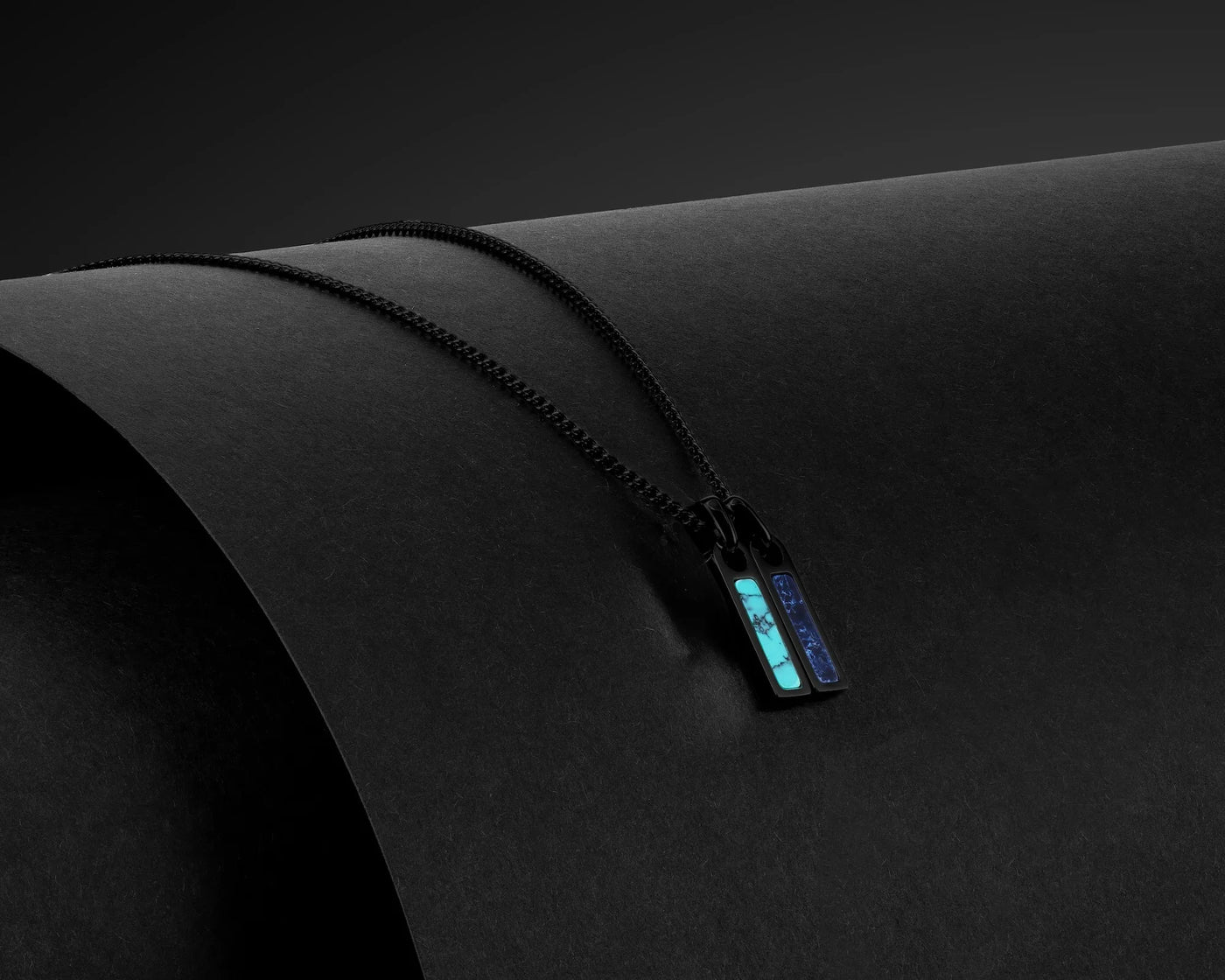 Black zipper with a label on a black background