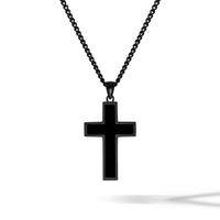 Black cross pendant on a chain against a white background