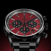 Black wristwatch with a red face and 'Vincero' branding on a dark background