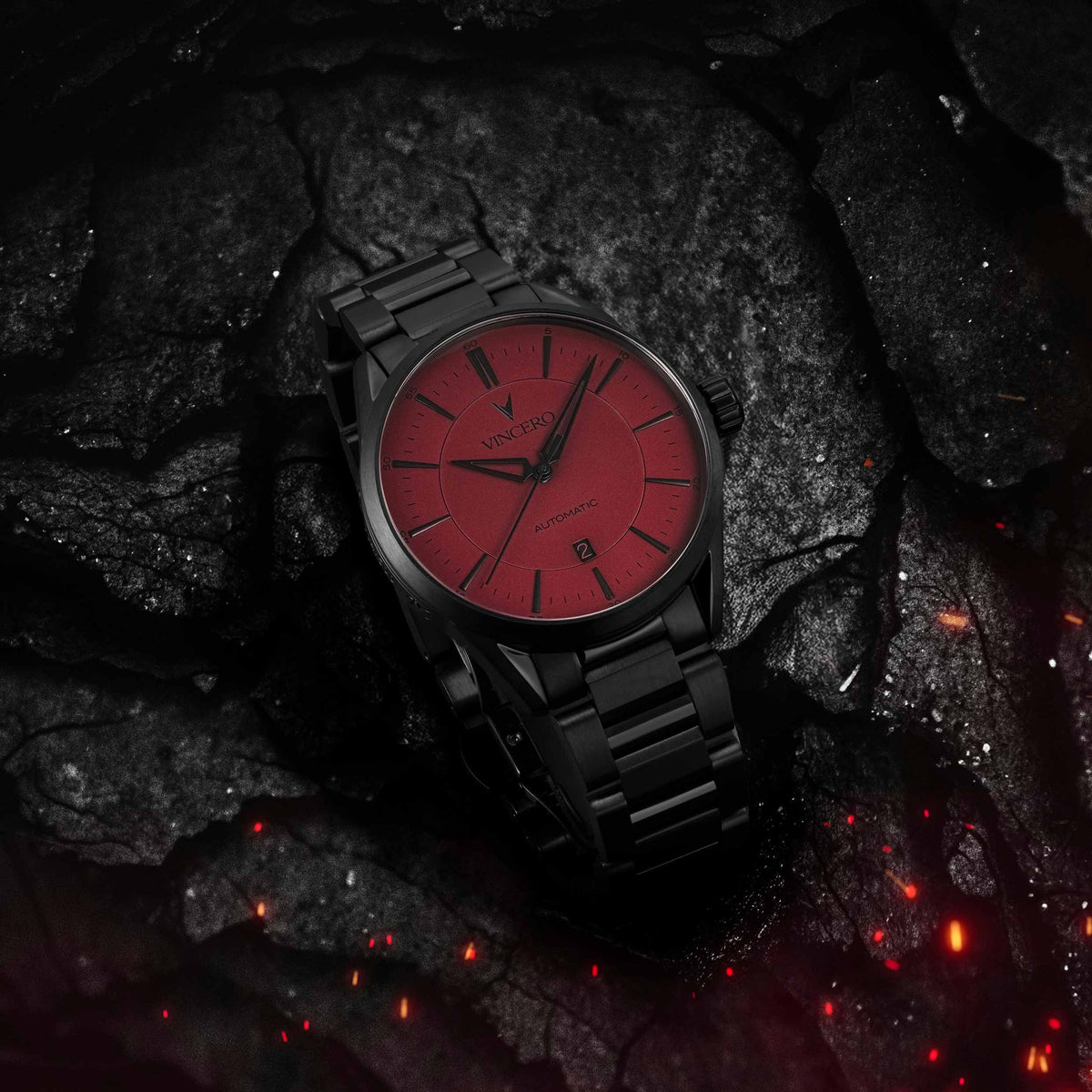 Black watch with red face on a dark, textured surface