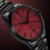 Watch with red face and black strap on a dark background