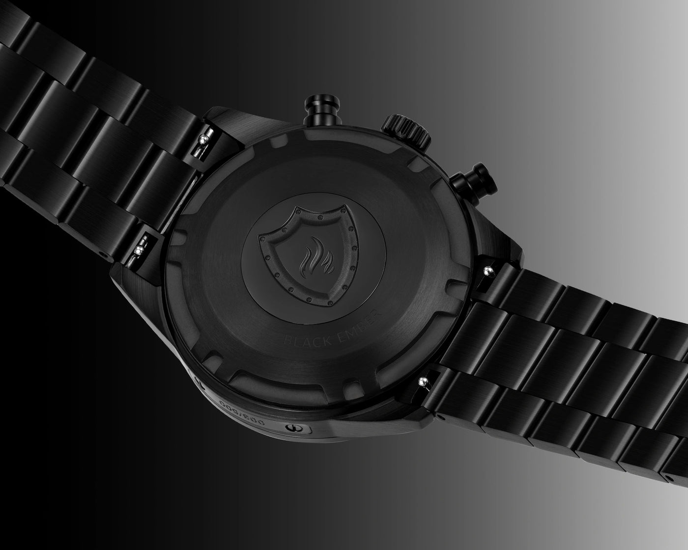 Black watch with a detailed face and metal strap on a gradient background