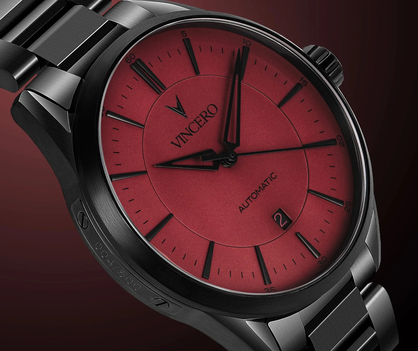 Watch with red face and black accents on a dark background