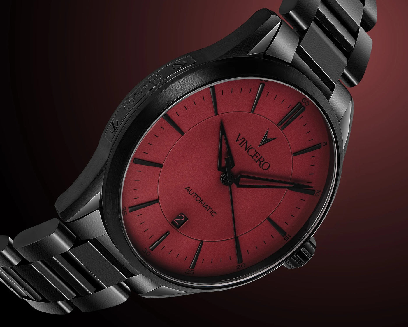 Watch with red face and black strap on a dark background