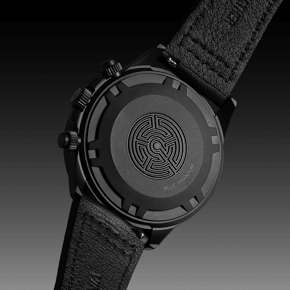 "Blue Phantom" text engraved on the back of a matte black watch.