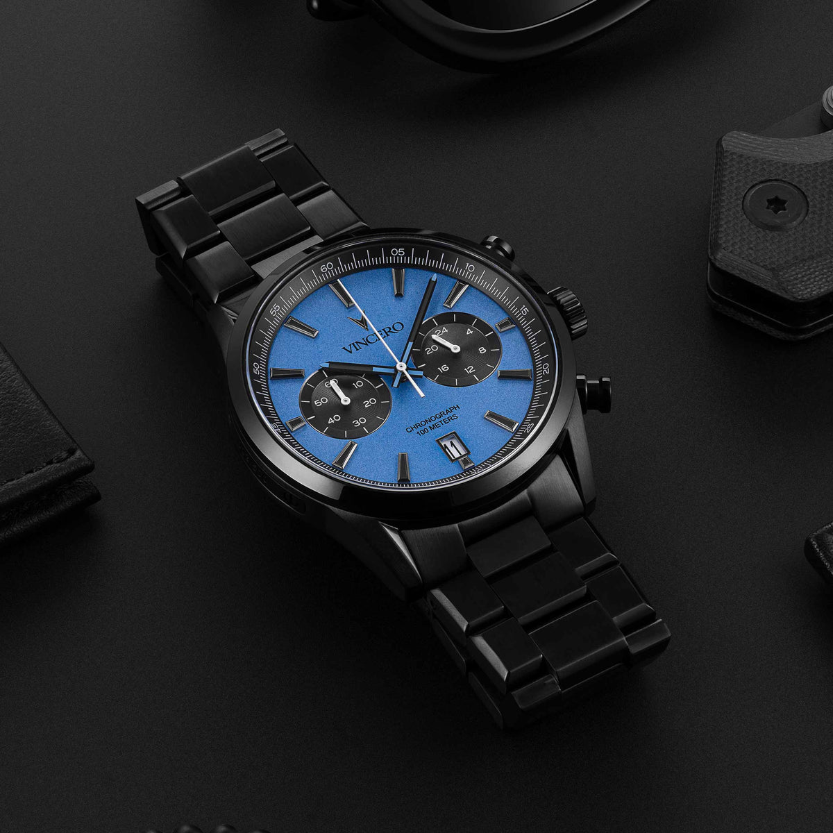 Chrono Limited Release watch, featuring a blue face and matte black band, displayed on a desk.