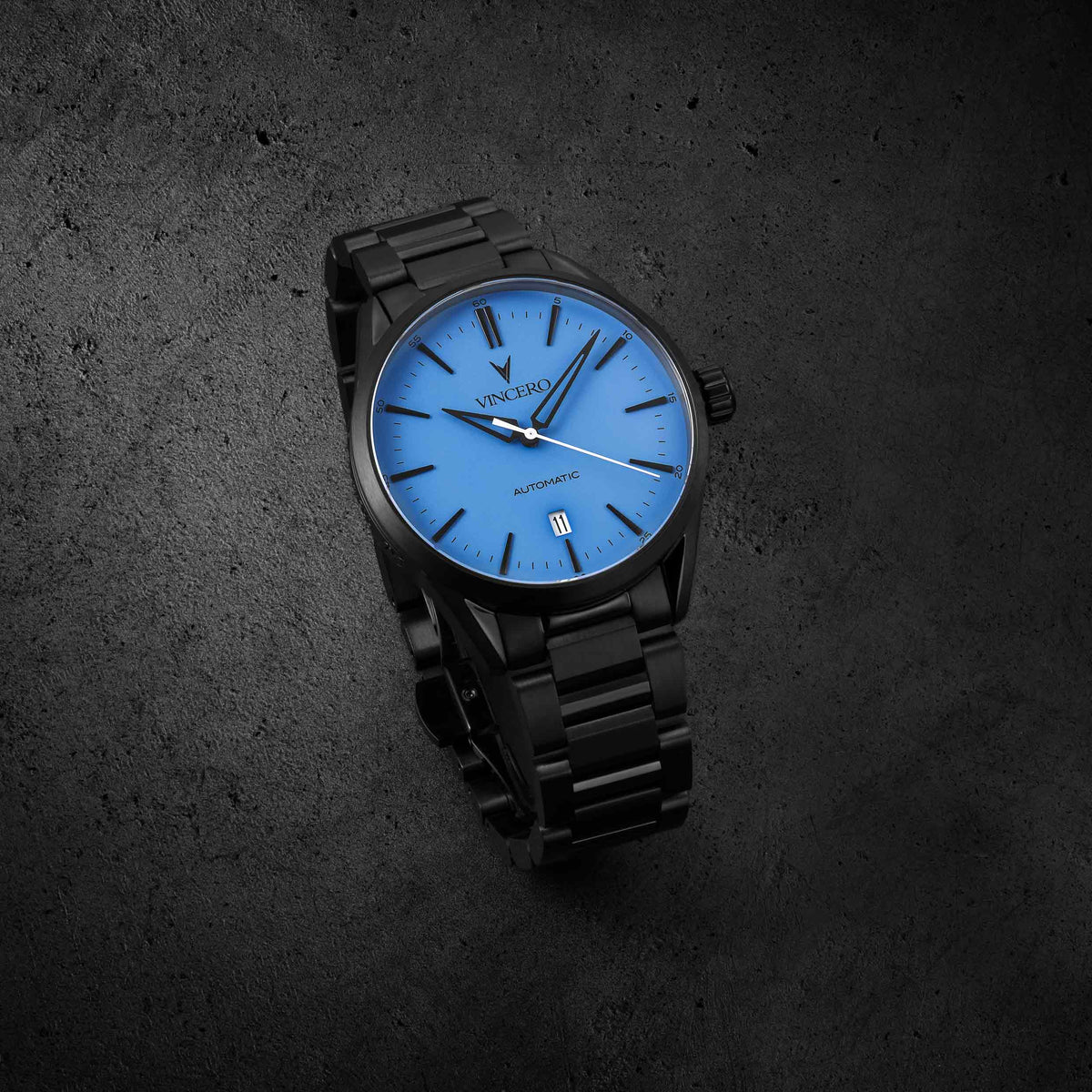 Icon Automatic watch, featuring a blue face and matte black band.