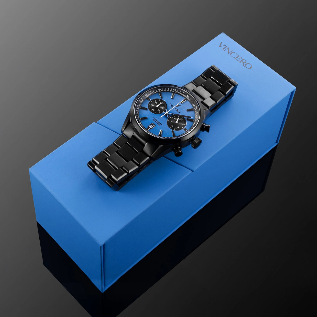 Chrono Limited Release with blue watch face and matte black watch band placed on blue packaging 
