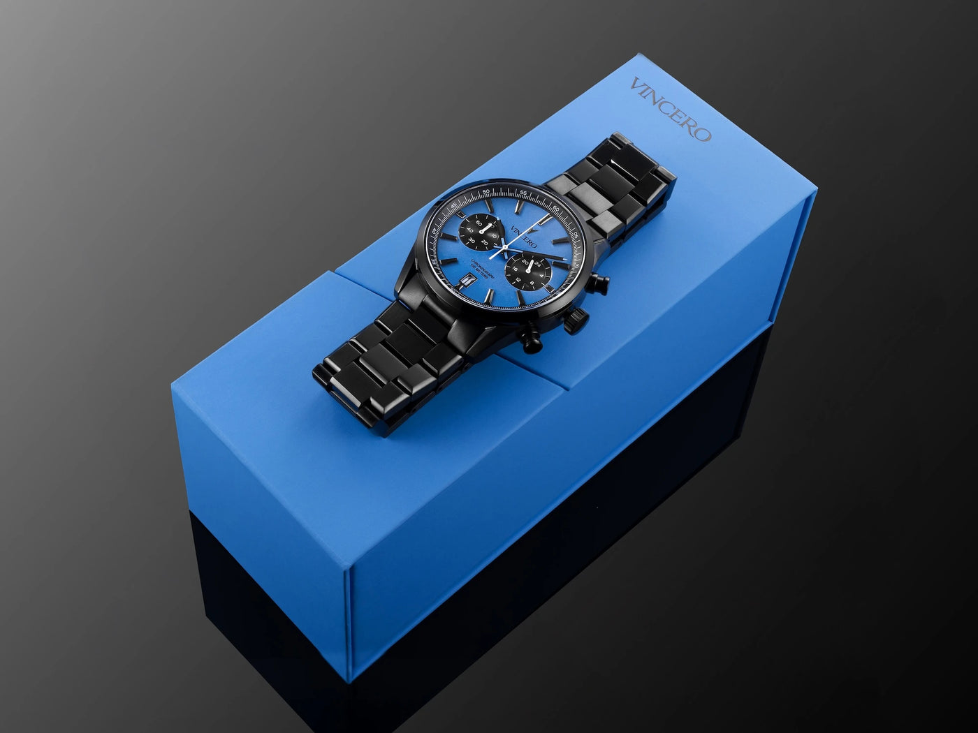 Chrono Limited Release with blue watch face and matte black watch band placed on blue packaging 