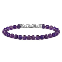 Purple beaded bracelet with a silver clasp on a white background