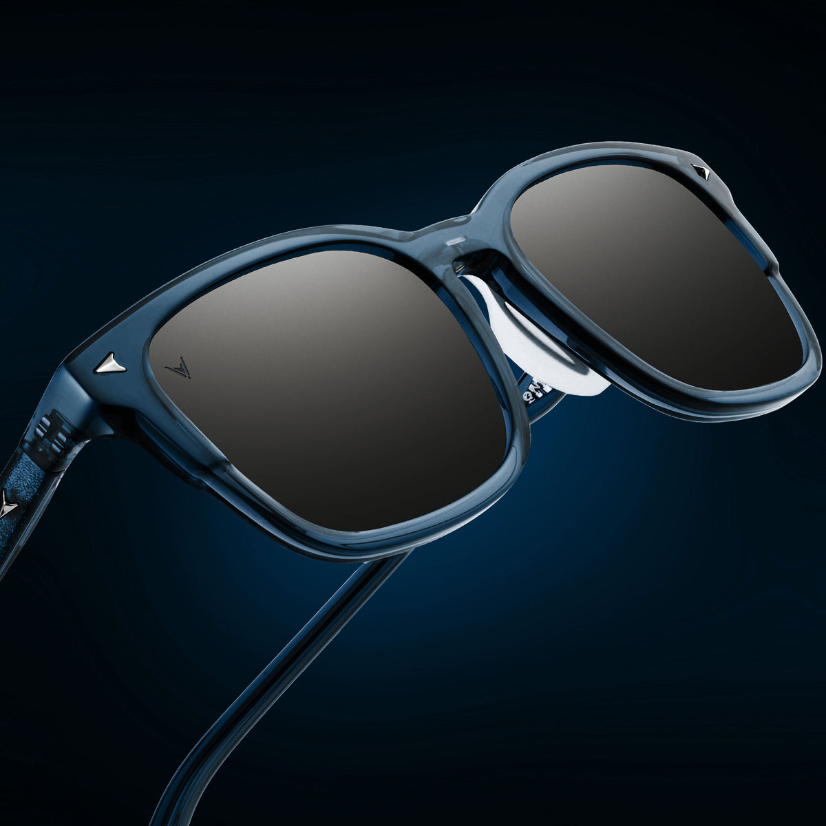 Blue sunglasses with dark lenses on a dark blue background
