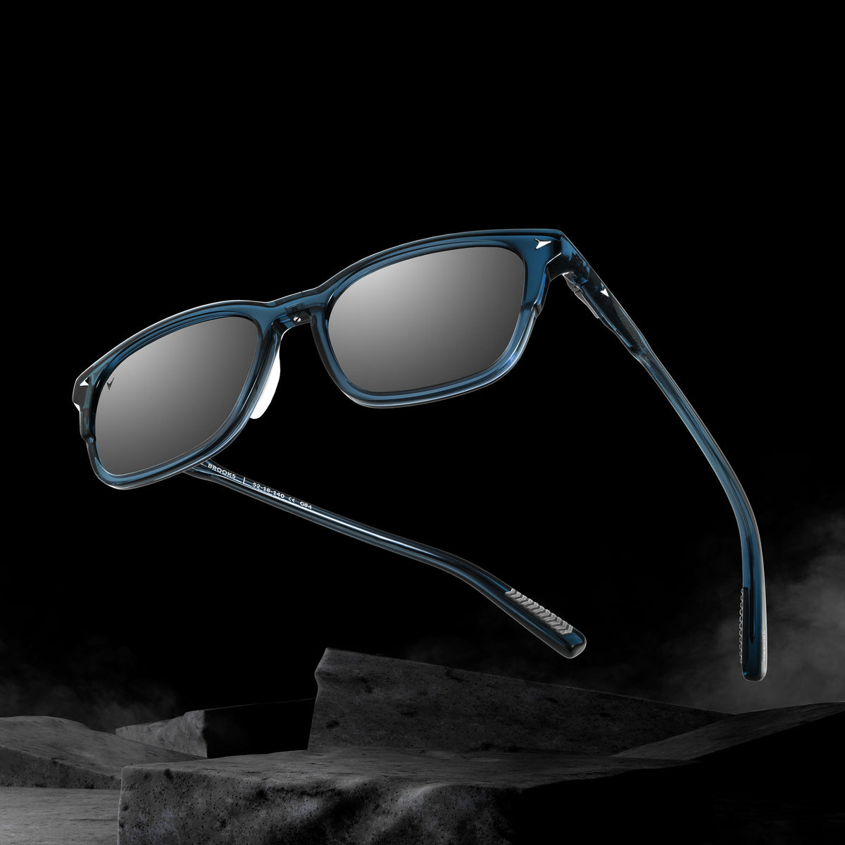 Blue sunglasses with dark lenses on a black background