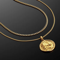 Gold chain necklace with a lion head pendant on a black background
