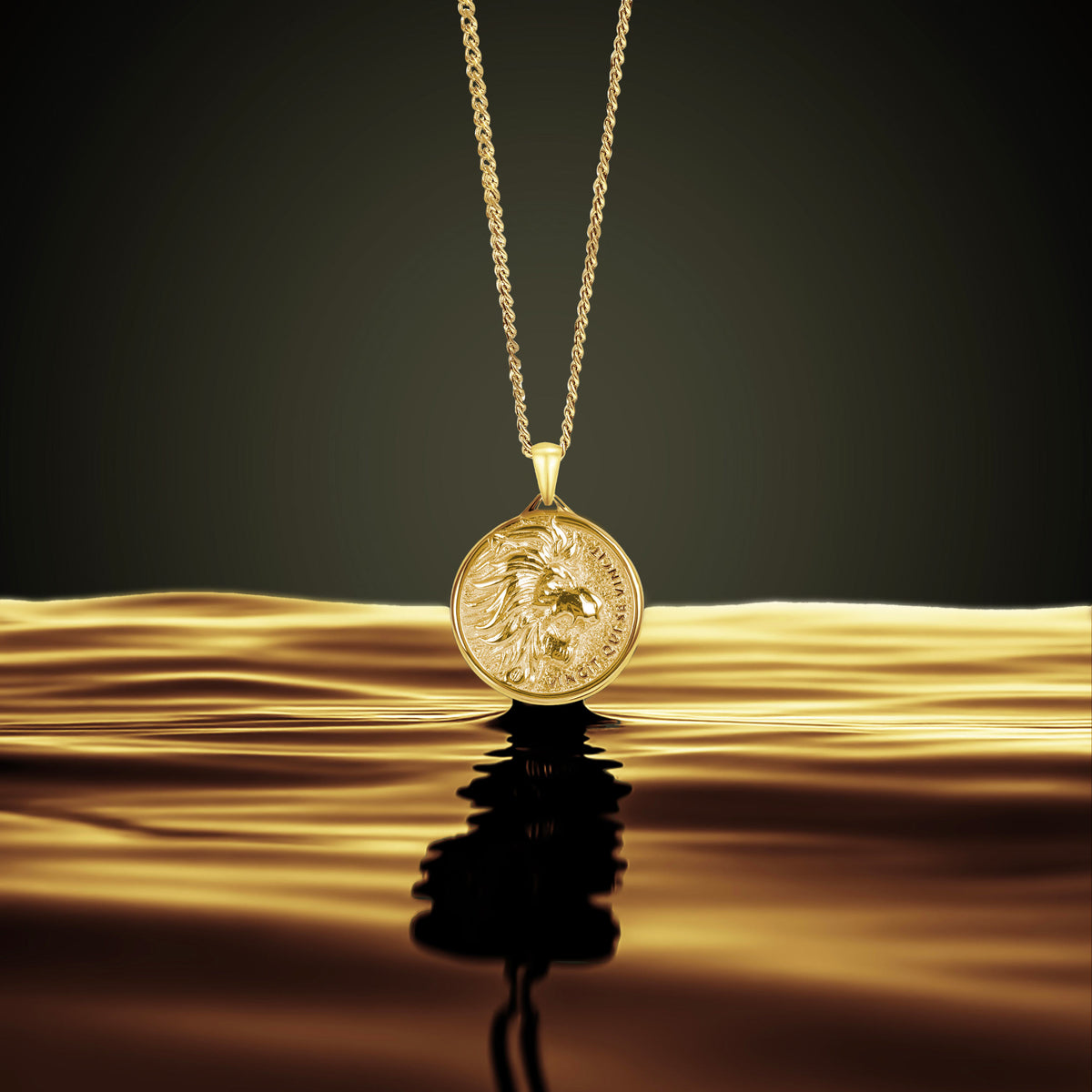Gold Lion necklace with a pendant on a reflective gold surface