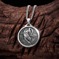 Silver lion pendant necklace on a wooden surface