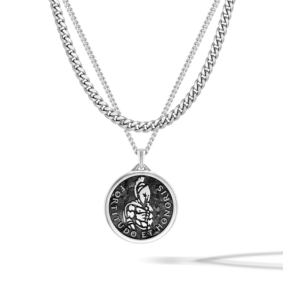 Silver necklace with a round pendant on a white background