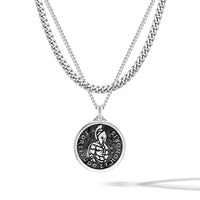 Silver necklace with a round pendant on a white background