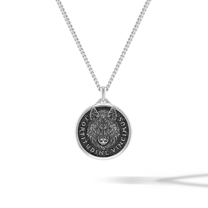 Silver necklace with a wolf pendant on a white background