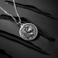 Silver lion pendant necklace on a black background