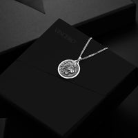 Silver necklace with a lion pendant on a black background