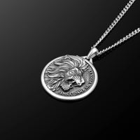Silver lion head pendant necklace on a black background