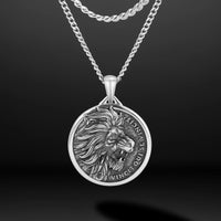 Silver lion pendant necklace on a dark background