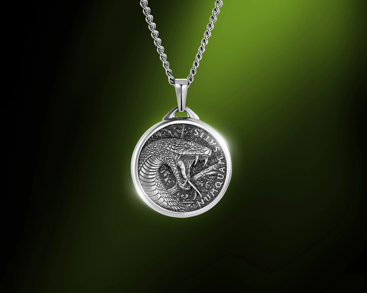 Men's black mamba pendant hanging on a green background 