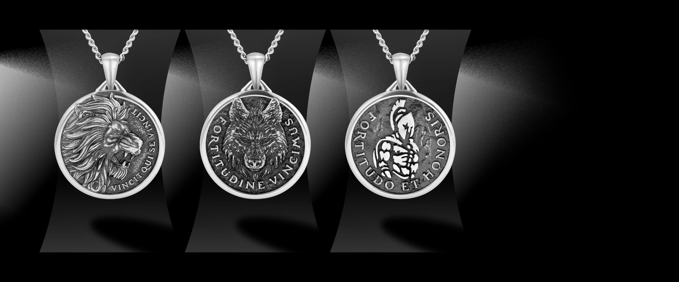 Three silver animal-themed pendants on a black background