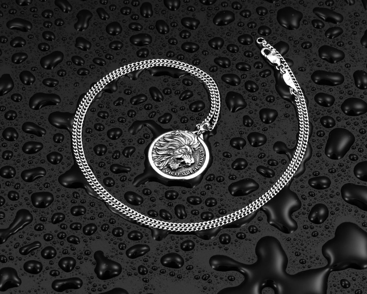 Silver chain necklace with silver lion pendant, surrounded by water droplets