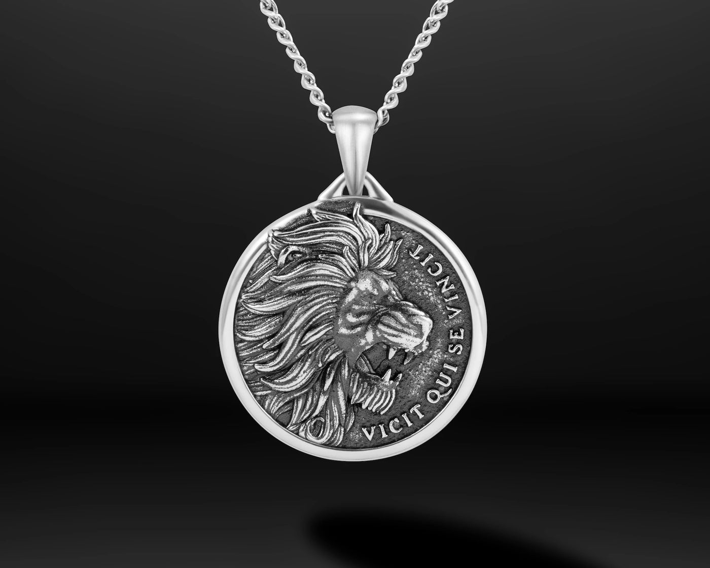 Close-up of a silver chain necklace with silver lion pendant 