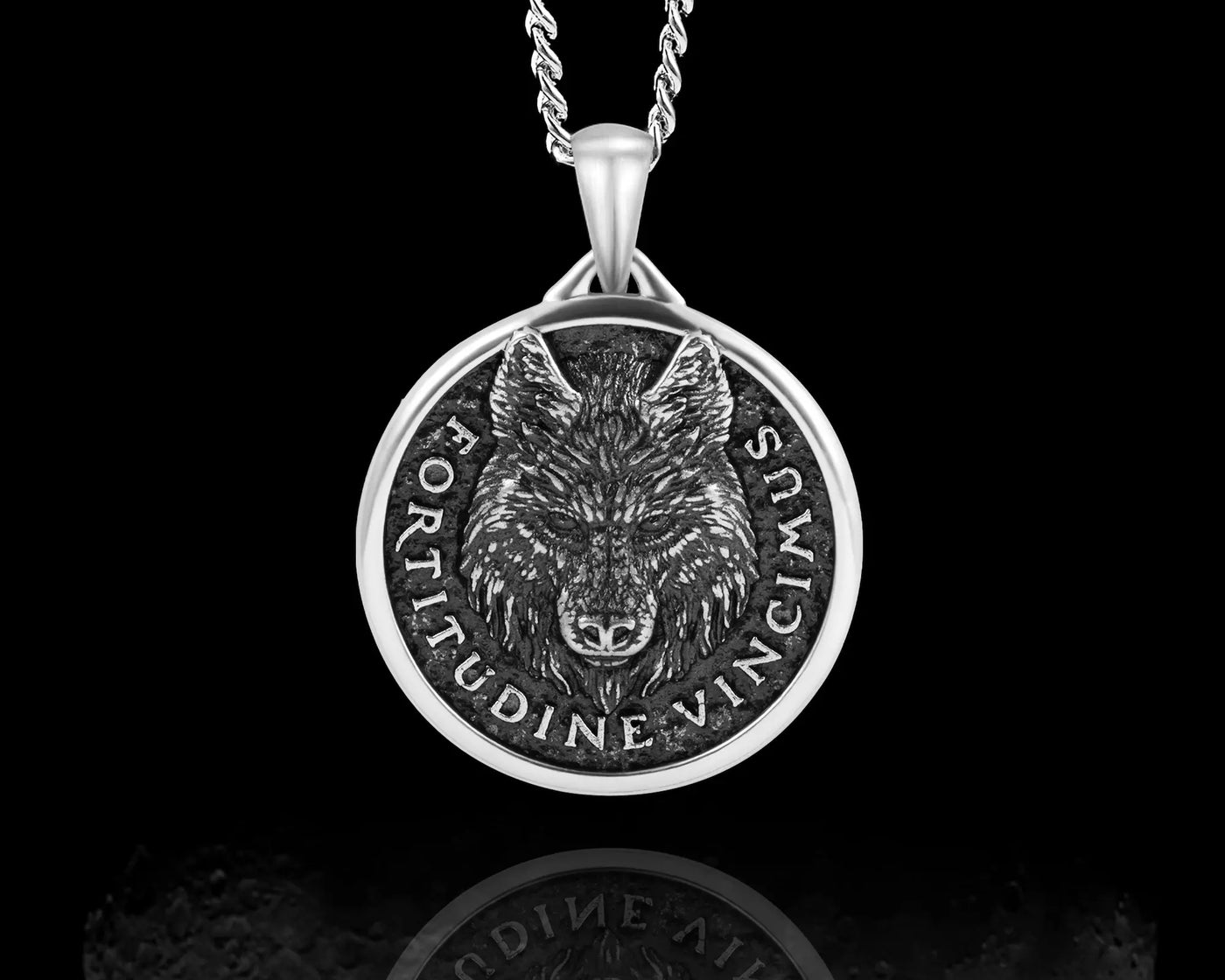 Close-up of a silver wolf pendant