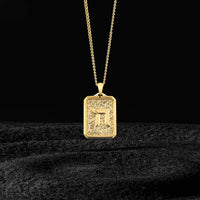 Gold pendant necklace on a black background
