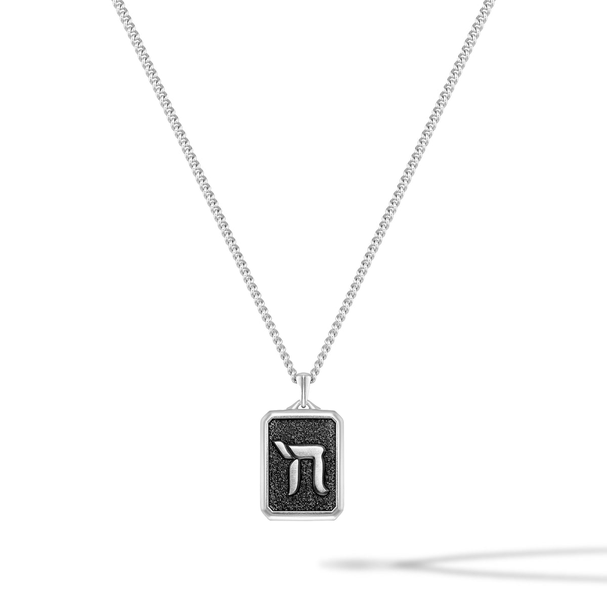 Necklace with a square pendant featuring a black symbol on a white background