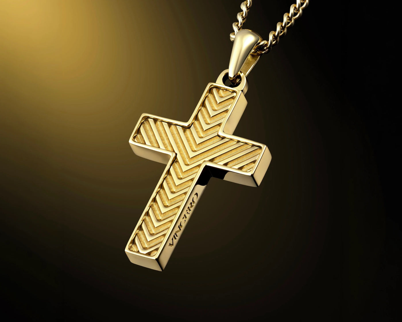 A gold cross pendant necklace with a textured chevron pattern and the words 'JESUS IS RIGH' engraved on the side, hanging from a gold chain against a dark gradient background.