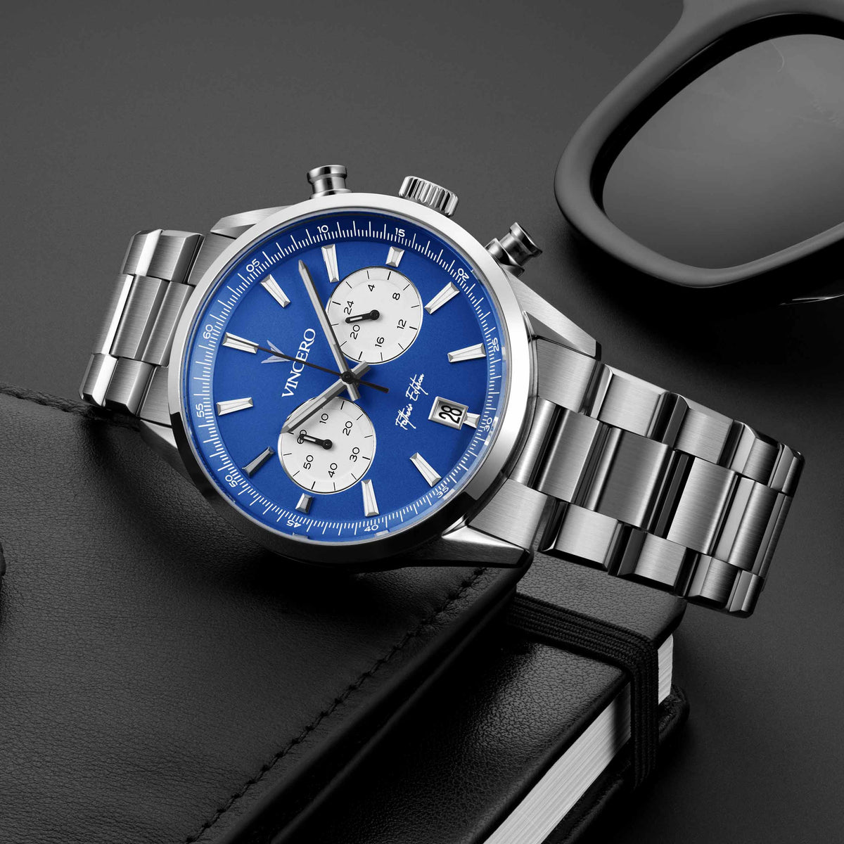Father’s Edition watch, featuring a blue face, stainless steel casing, and steel band, displayed on its side.
