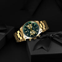 Gold wristwatch with a green face on a black background