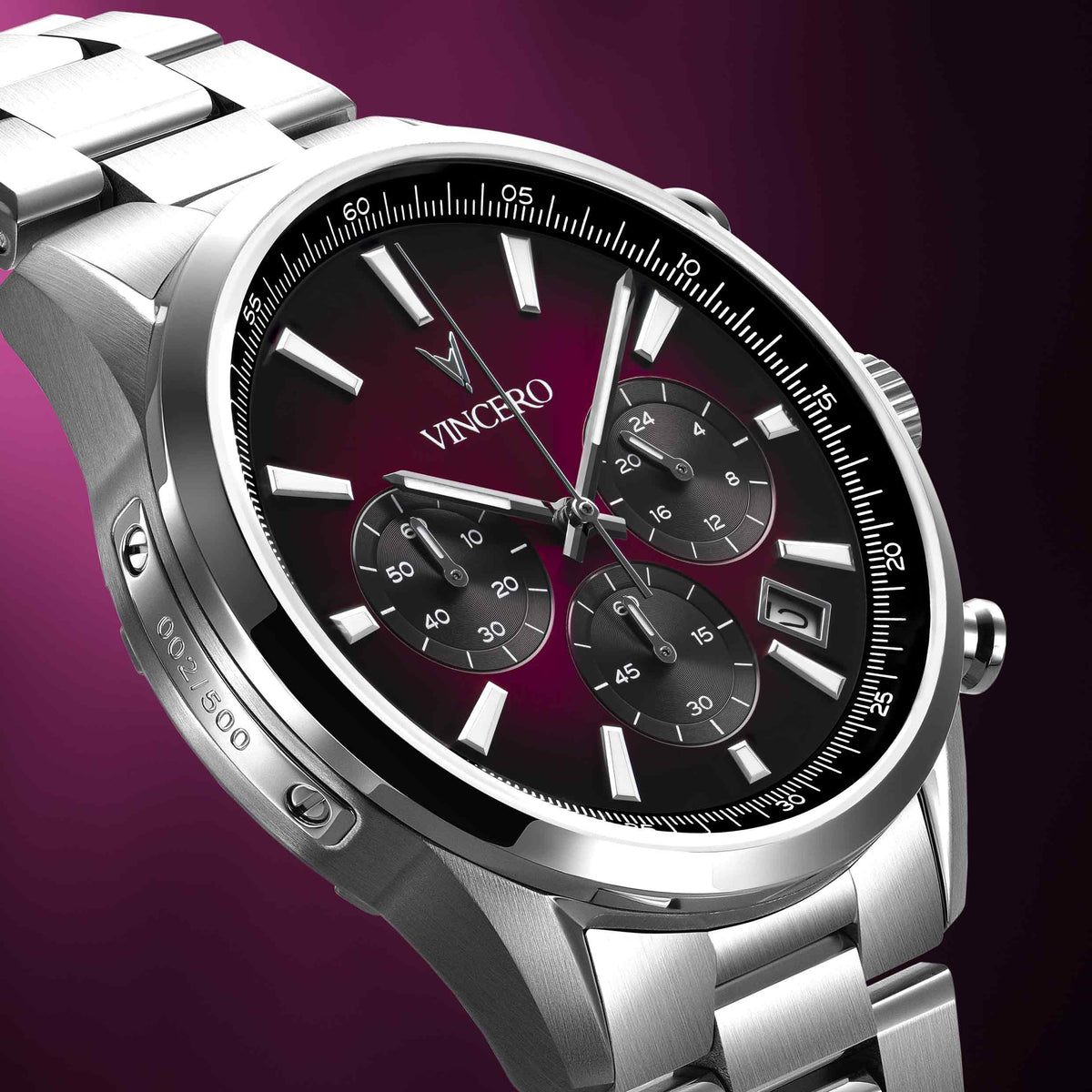 Silver wristwatch with a black face on a purple background