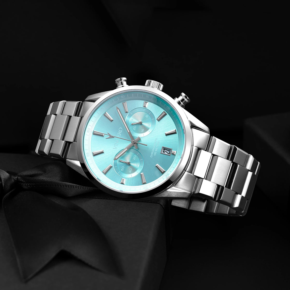Chrono Limited Release watch, featuring a Carolina blue face, stainless steel casing, and steel band, displayed on its side.