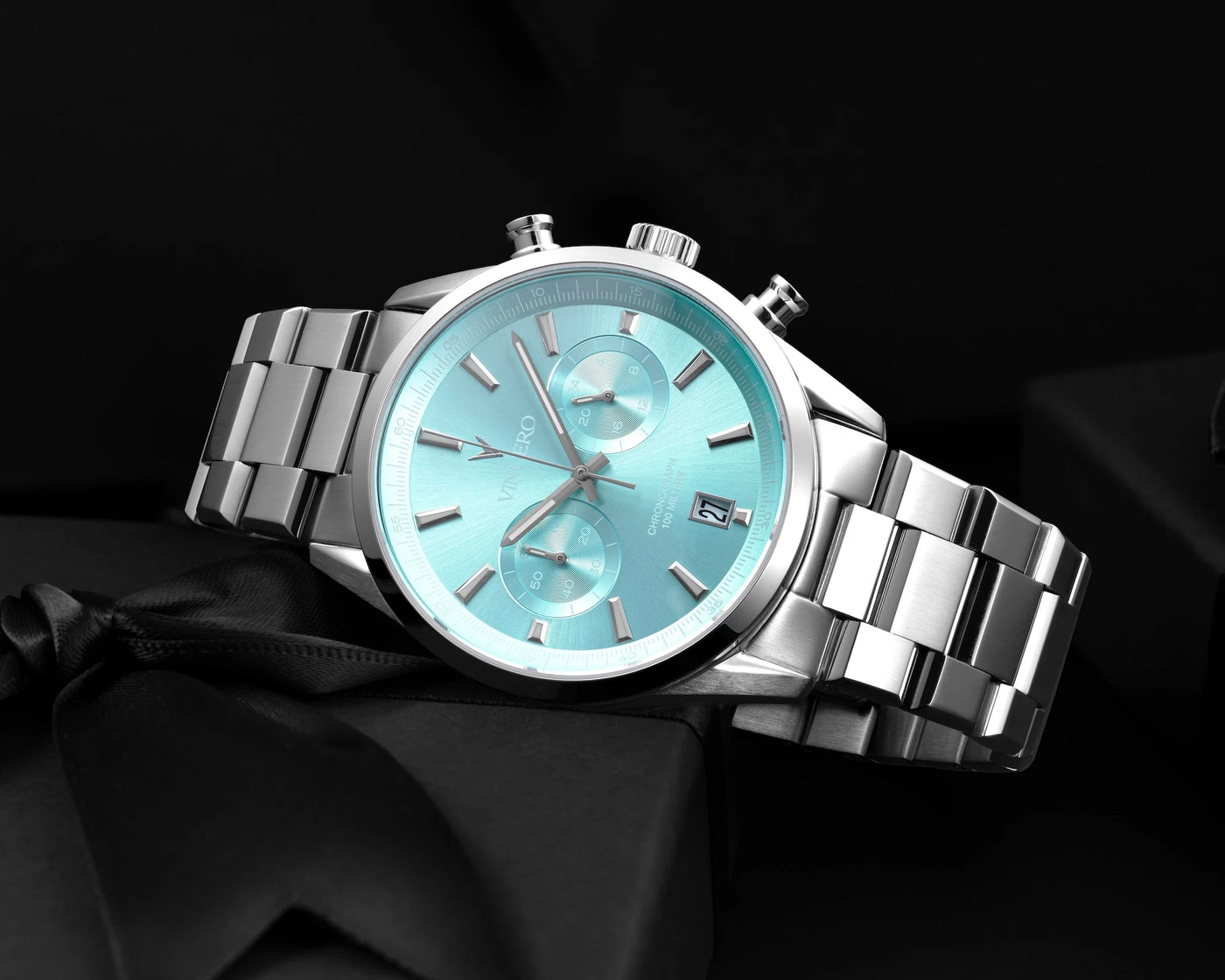 Chrono Limited Release watch, featuring a Carolina blue face, stainless steel casing, and steel band, displayed on its side.