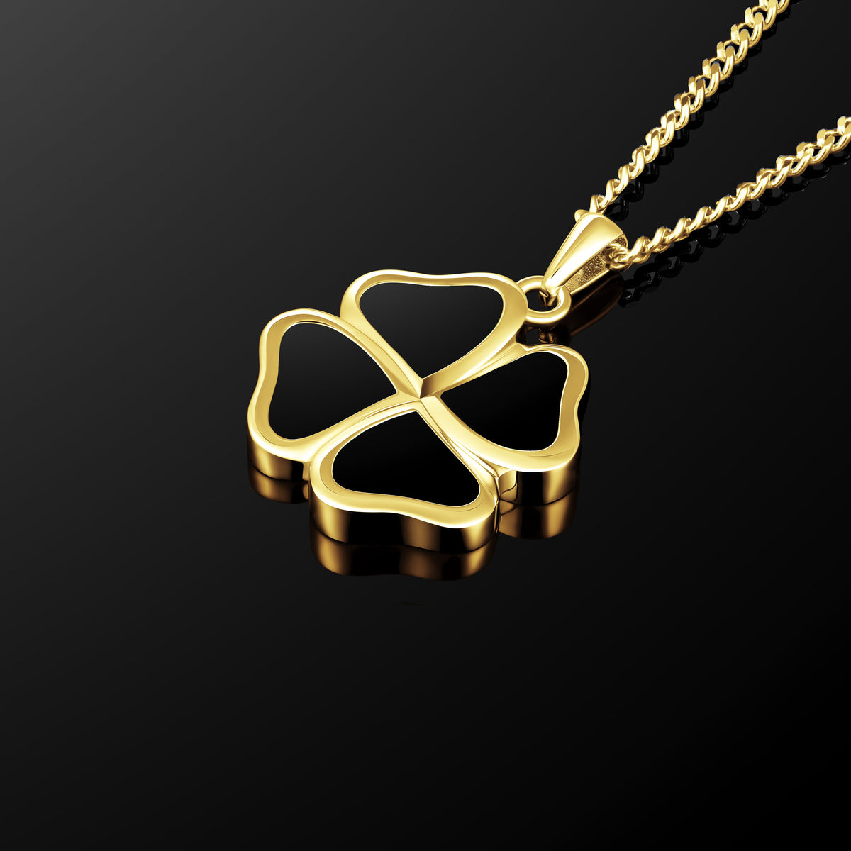 Gold four-leaf clover pendant on a black background