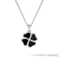 A sterling silver four-leaf clover pendant necklace with black enamel inlay, suspended from a silver box chain against a white background.