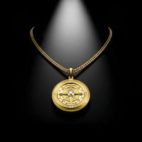 Gold necklace with a detailed pendant on a black background