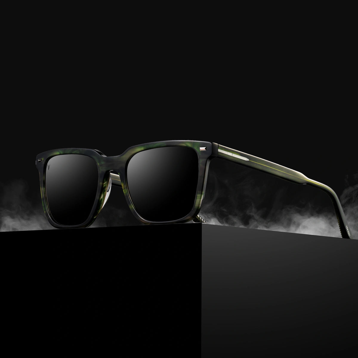 Sunglasses with green frame and dark lenses on a black background